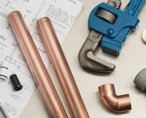 Running a snake for a Seattle drain cleaning job on a clogged tub